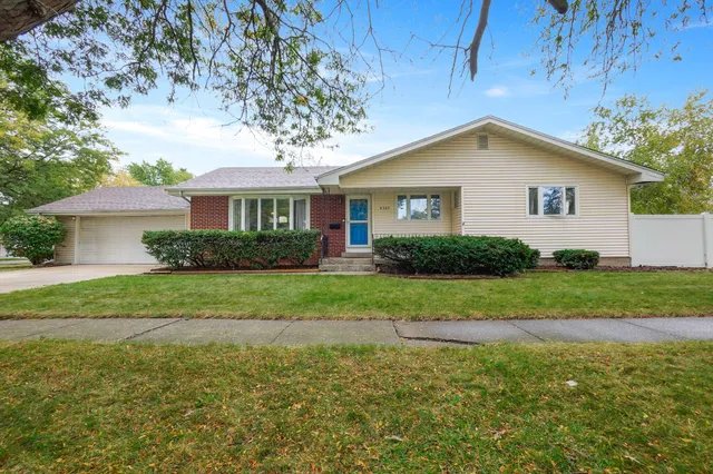 a house with green field in front of it