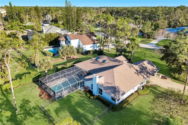 an aerial view of a house with a garden and swimming pool