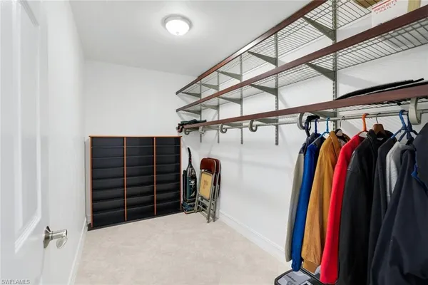 a spacious bedroom with a bed and ceiling fan
