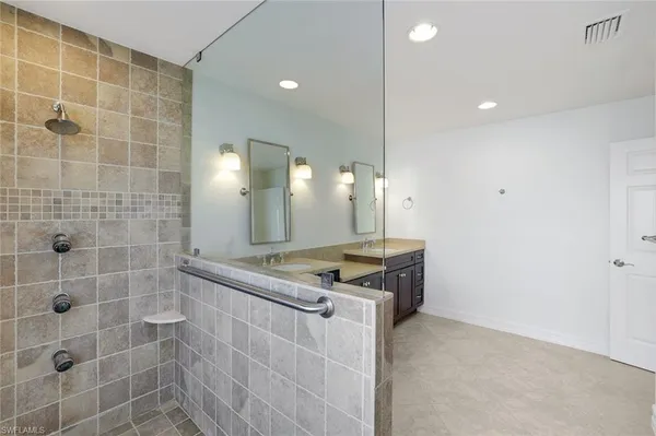a large bathroom with a double vanity sink and a mirror