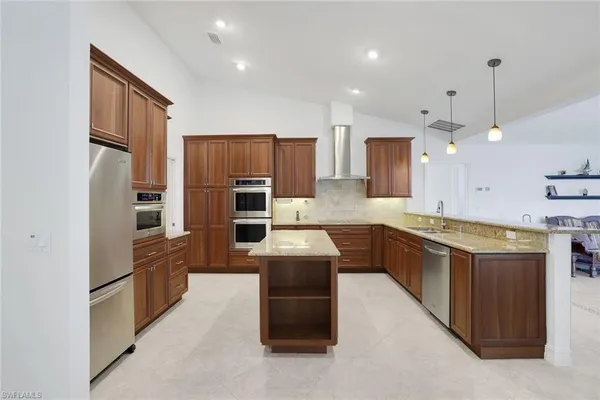 a kitchen with stove and cabinets
