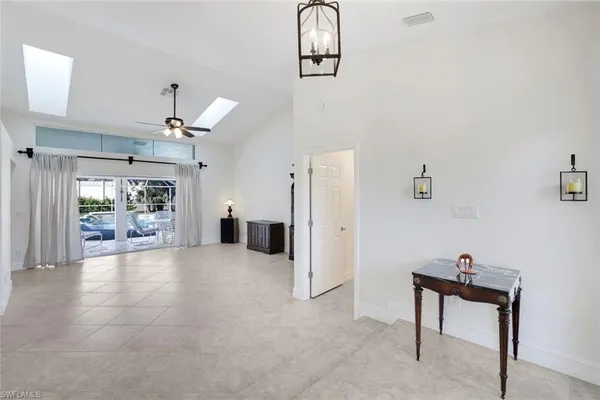 a living room with furniture and a ceiling fan