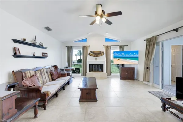 a living room with furniture fireplace and a large window