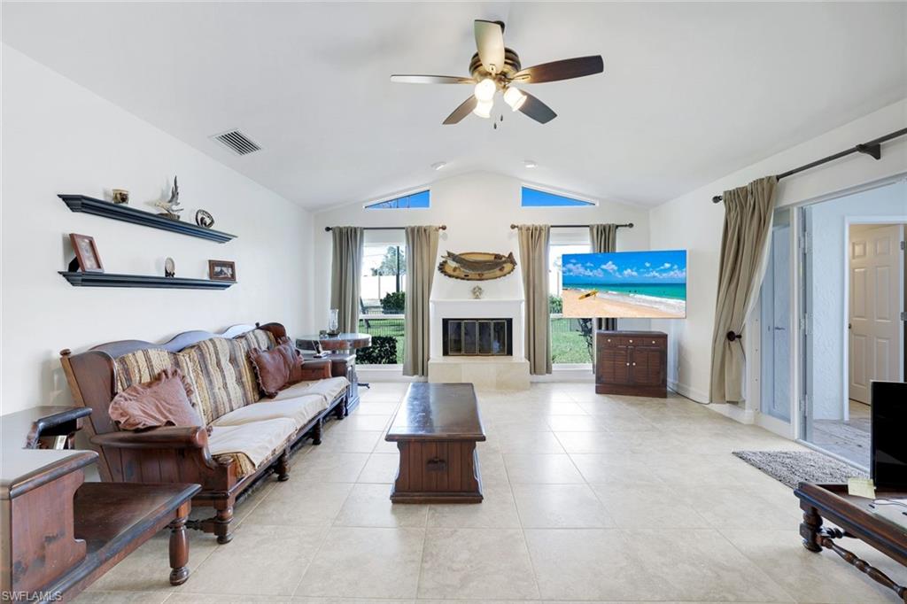 1819 Princess Court Naples, FL 34110 - Photo 8 of 25 a living room with furniture and a fireplace