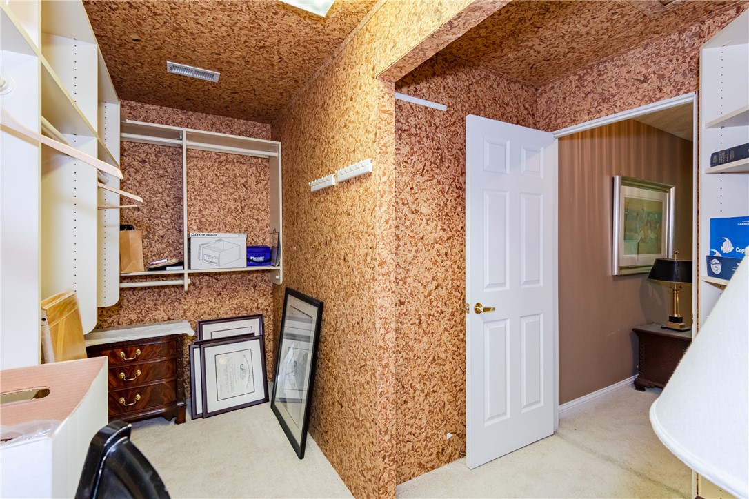 1105 Napa Ridge Dayton, OH 45458 - Photo 36 of 58 This spacious walk-in closet offers extensive storage solutions with built-in shelving and soft carpeting.