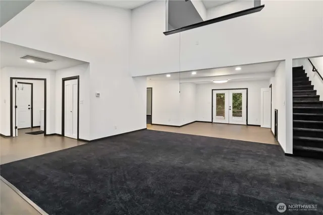 an entryway of a house with wooden floor and stairs