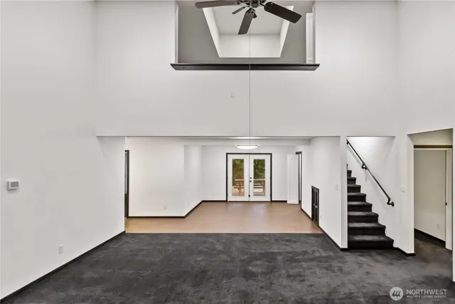 a view of empty room with kitchen