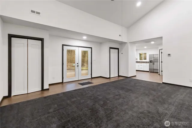 a kitchen with granite countertop white cabinets and white appliances
