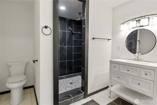 a bathroom with a shower and a mirror