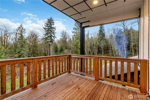 a view of a porch with furniture and wooden floor