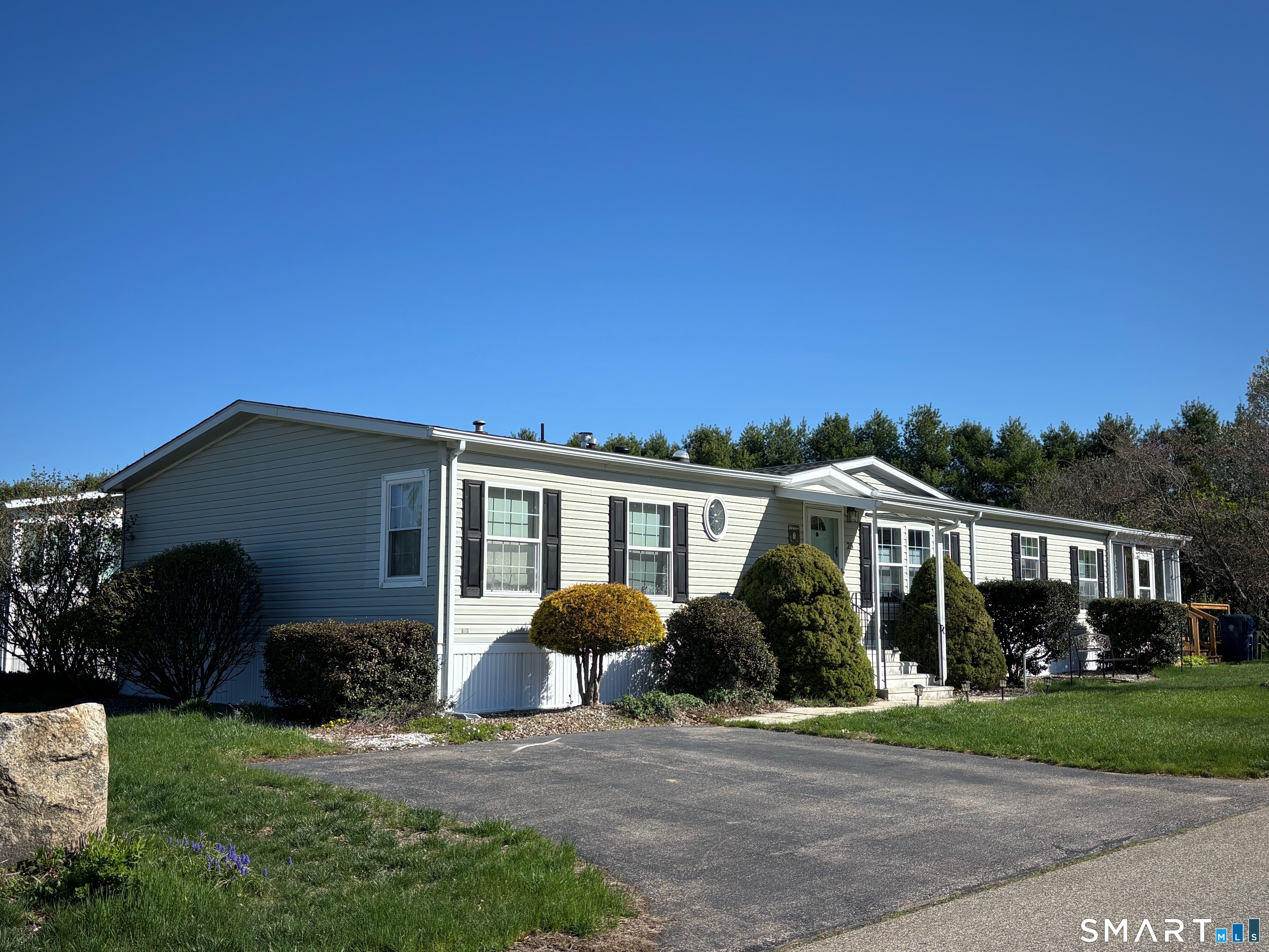25 Kitty Lane Windham, CT 06256 - Photo 39 of 39 a front view of a house with a yard and potted plants