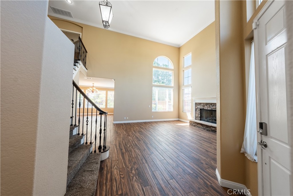 31465 Inverness Court Temecula, CA 92591 - Photo 11 of 71 a view of a hallway with wooden floor and staircase