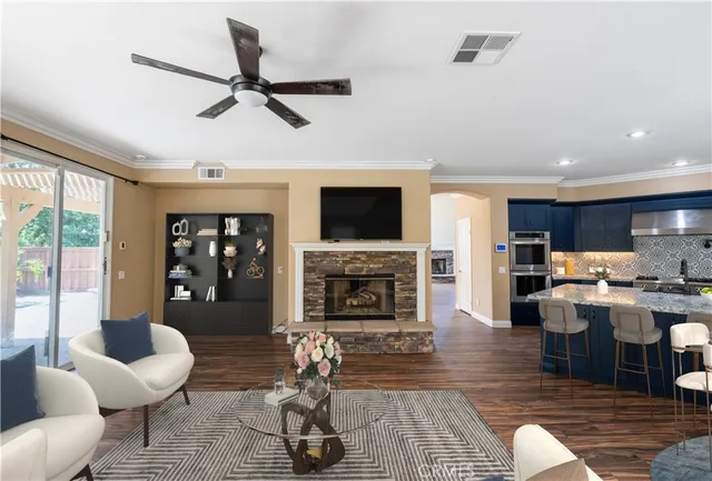 a kitchen with granite countertop kitchen island stainless steel appliances a refrigerator a stove a sink a dining table and chairs