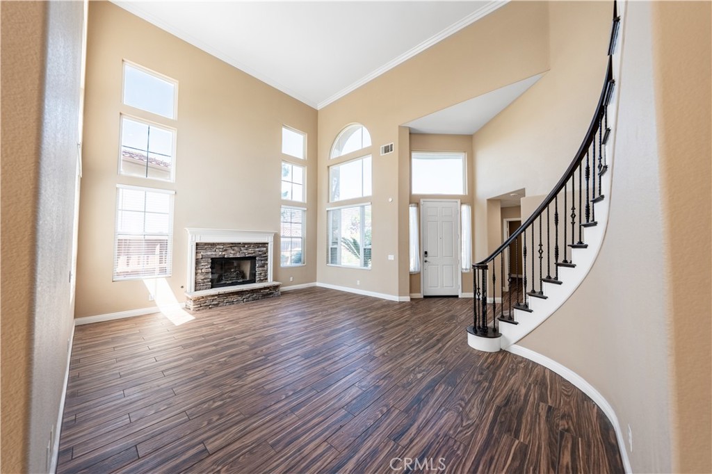 31465 Inverness Court Temecula, CA 92591 - Photo 14 of 71 a view of an empty room with wooden floor fireplace and a window