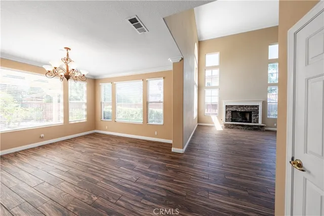 a view of a livingroom with furniture window and wooden floor