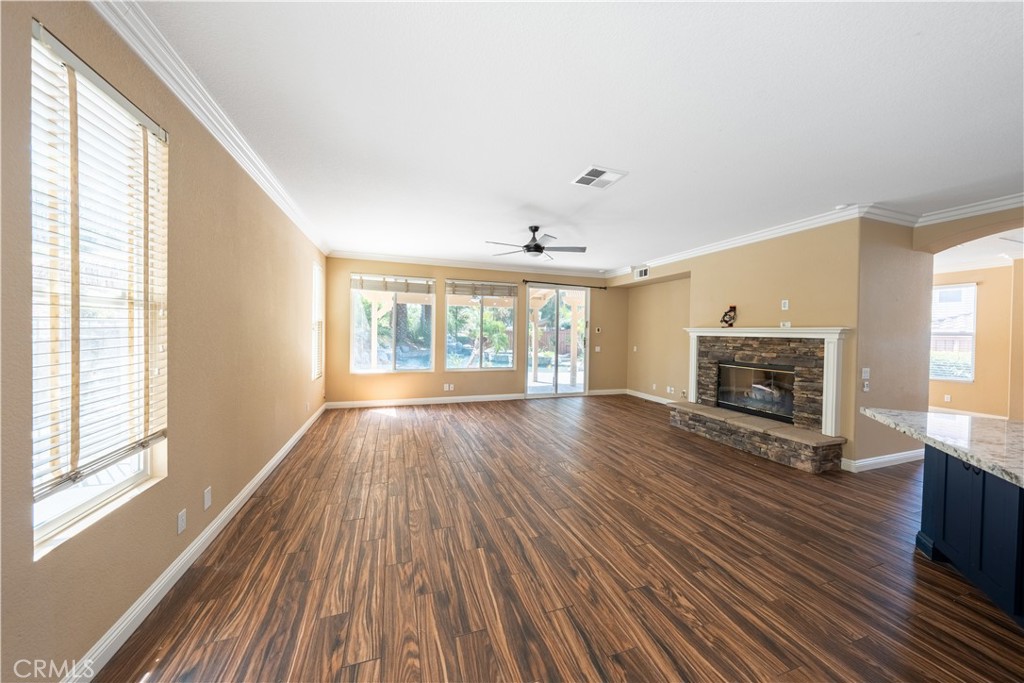 31465 Inverness Court Temecula, CA 92591 - Photo 16 of 71 a view of wooden floor fire place and windows in an empty room