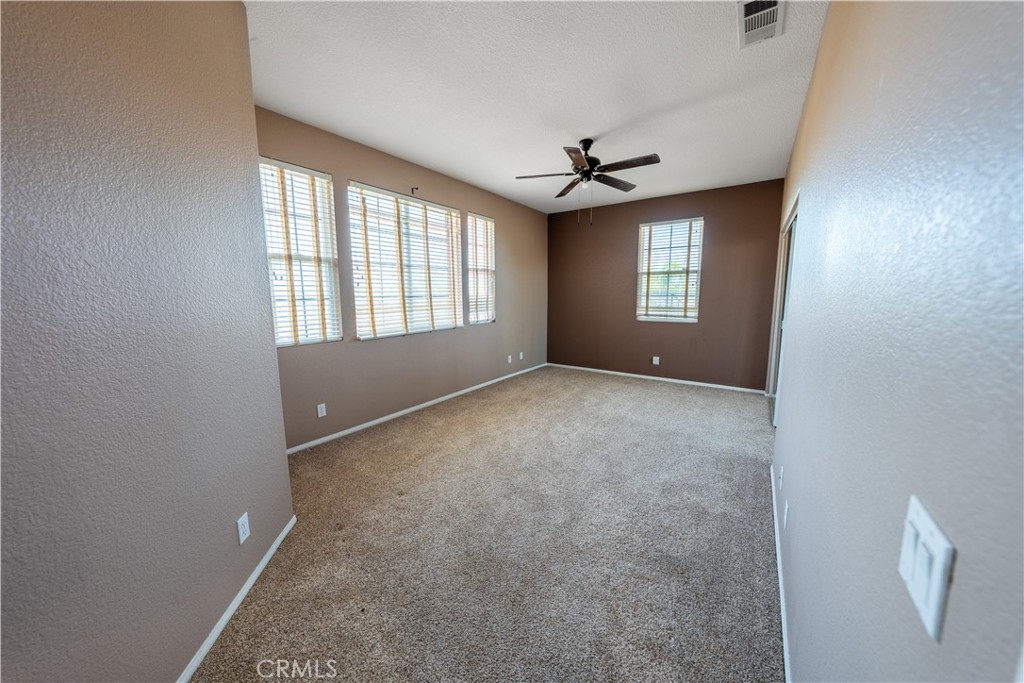 31465 Inverness Court Temecula, CA 92591 - Photo 32 of 71 an empty room with windows and ceiling fan