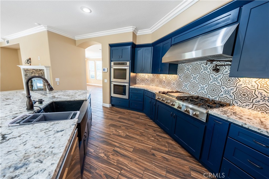 31465 Inverness Court Temecula, CA 92591 - Photo 40 of 71 a kitchen with granite countertop a sink stove and refrigerator