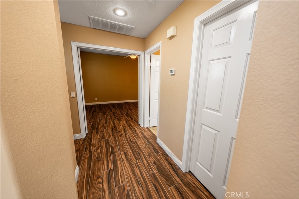 31465 Inverness Court Temecula, CA 92591 - Photo 43 of 71 a view of a hallway with wooden floor and staircase