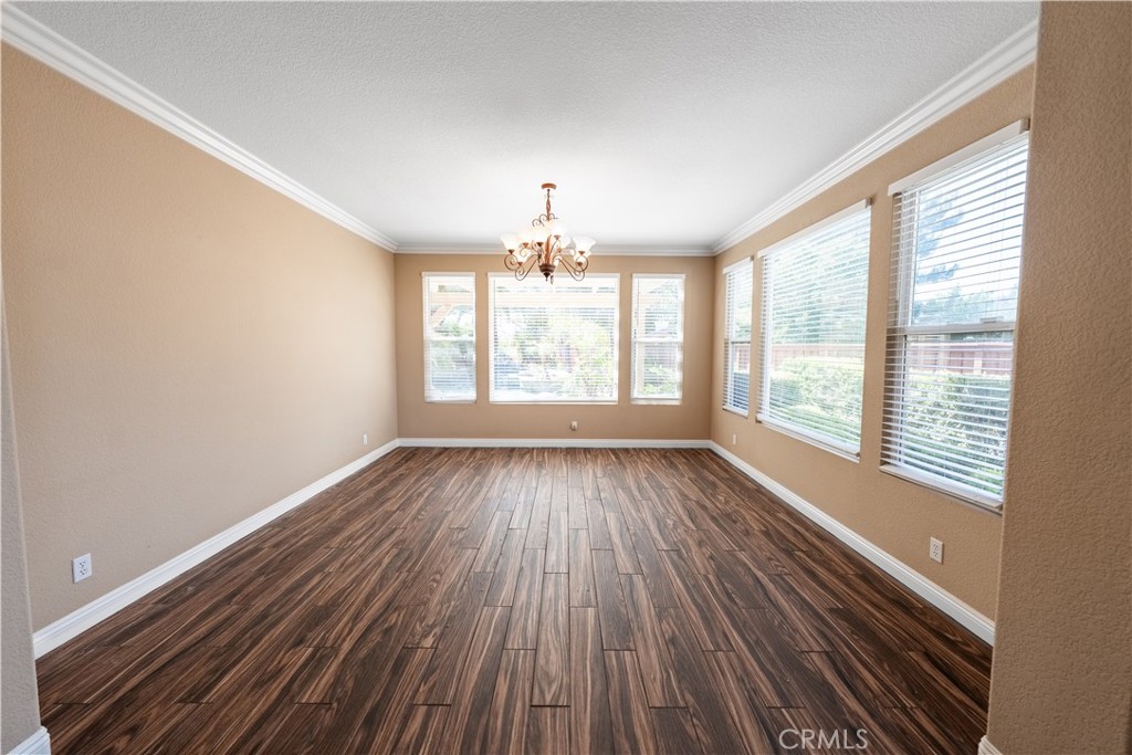 31465 Inverness Court Temecula, CA 92591 - Photo 45 of 71 a view of an empty room with wooden floor and a window