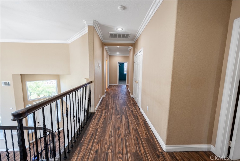 31465 Inverness Court Temecula, CA 92591 - Photo 48 of 71 a view of a hallway view with wooden floor and staircase