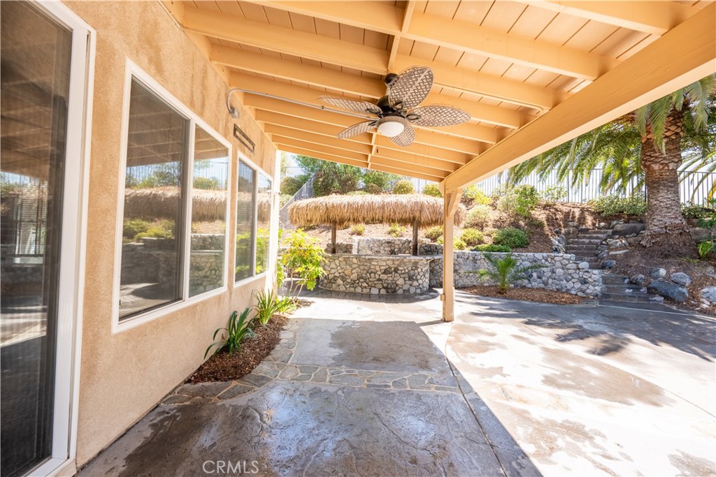 31465 Inverness Court Temecula, CA 92591 - Photo 57 of 71 a view of a patio with a table and chairs and floor to ceiling window