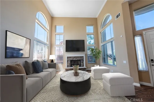a living room with fireplace furniture and a flat screen tv