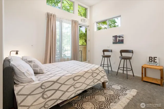 a bedroom with a bed a table and chair