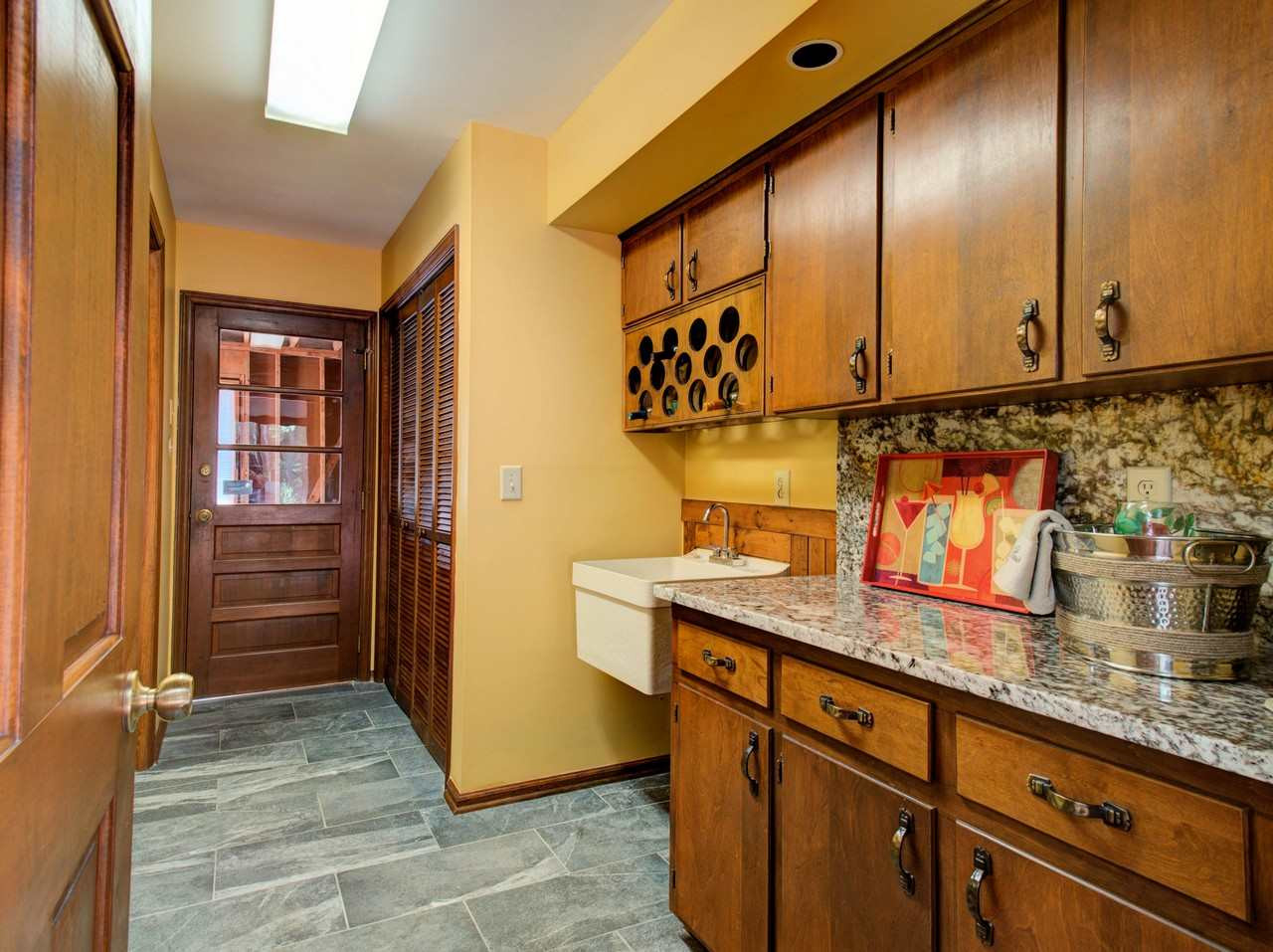 8316 Heel Stone Court Raleigh, NC 27613 - Photo 15 of 25 Exit through garage -excellent traffic pattern from car to house - two steps Wet Bar & Laundry