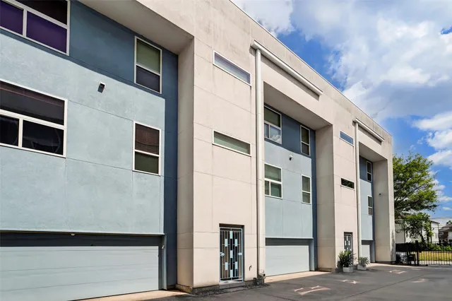 a front view of a building with a blue gate