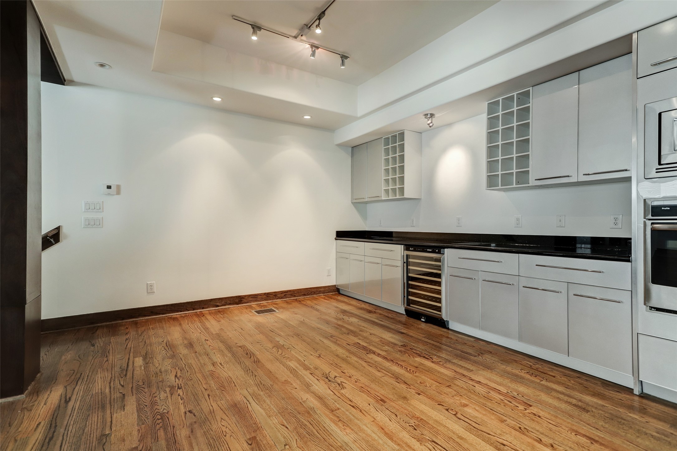1820 Prospect Street Houston, TX 77004 - Photo 12 of 18 an empty room with wooden floor and cabinet
