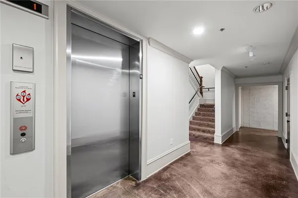a view of a hallway with wooden floor and entryway
