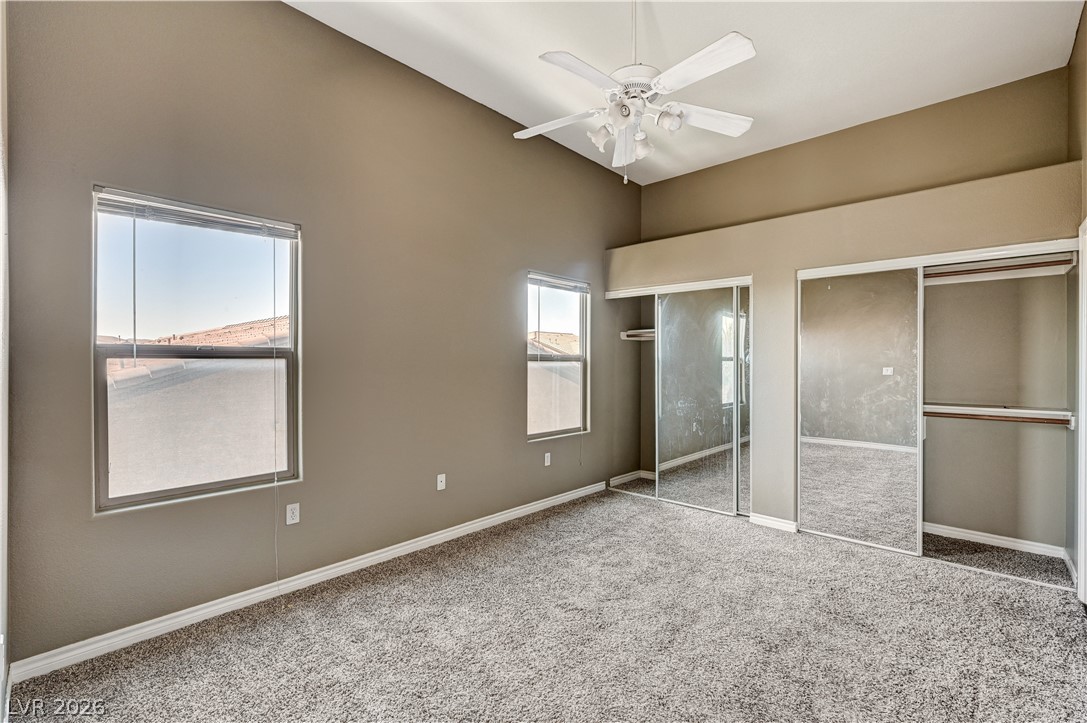 8985 South Durango Drive, Unit 2187 Las Vegas, NV 89113 - Photo 14 of 73 A quiet retreat, this bedroom offers vaulted ceilings and generous mirrored closet space.
