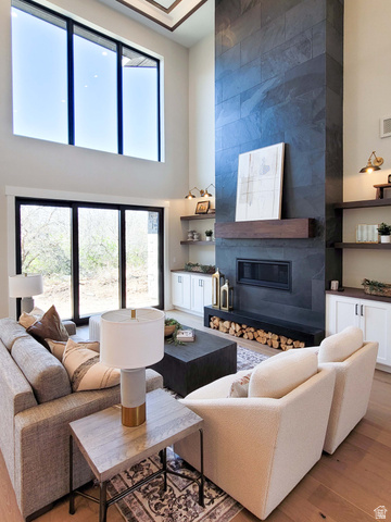 1303 East Lasso Trail, Unit R6 Kamas, UT 84036 - Photo 11 of 31 Two-story living area featuring a full-height stone-clad fireplace with a dark wood mantel and integrated firebox