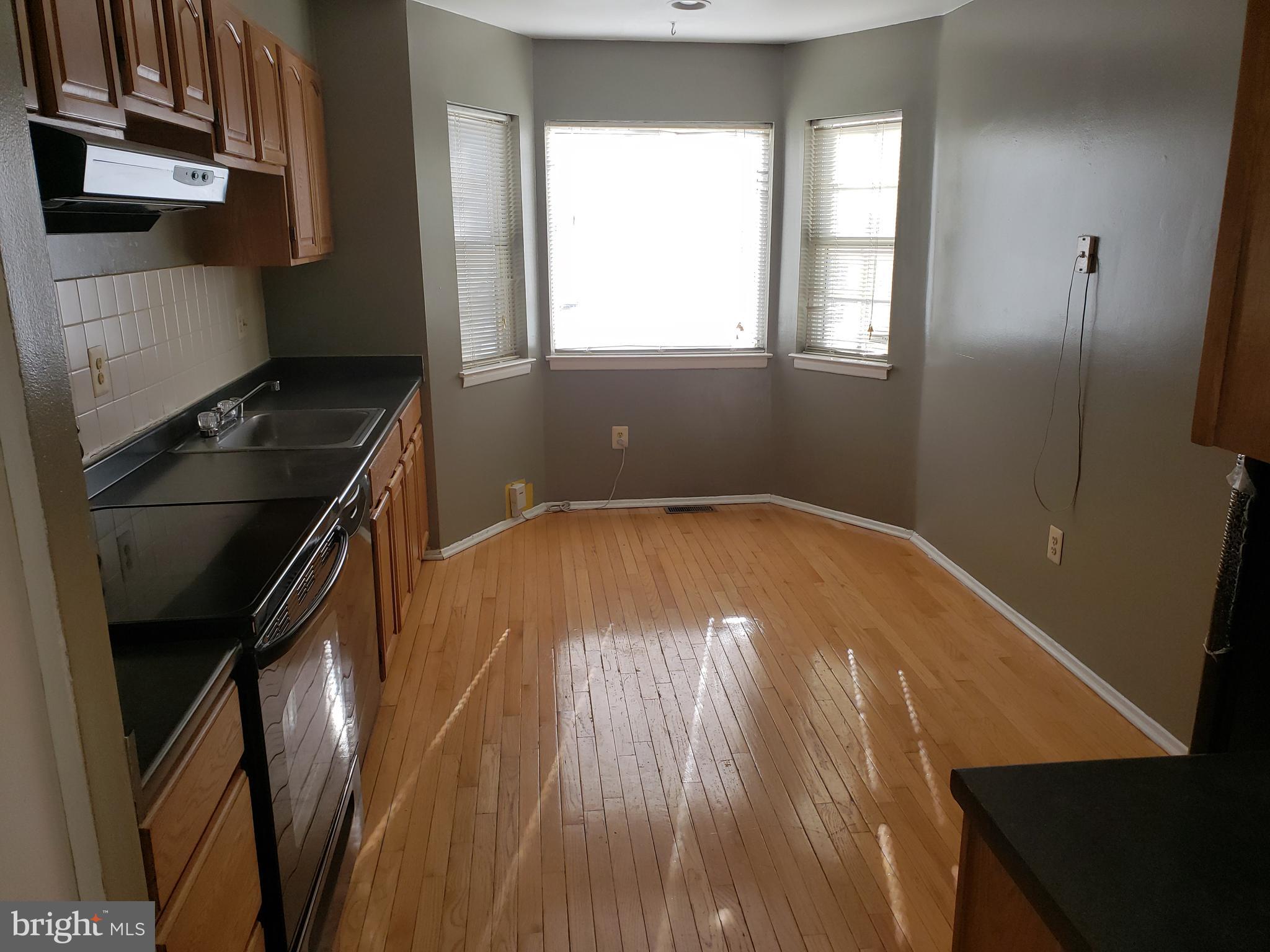 4 Mainview Court Randallstown, MD 21133 - Photo 4 of 25 an empty room with wooden floor and windows