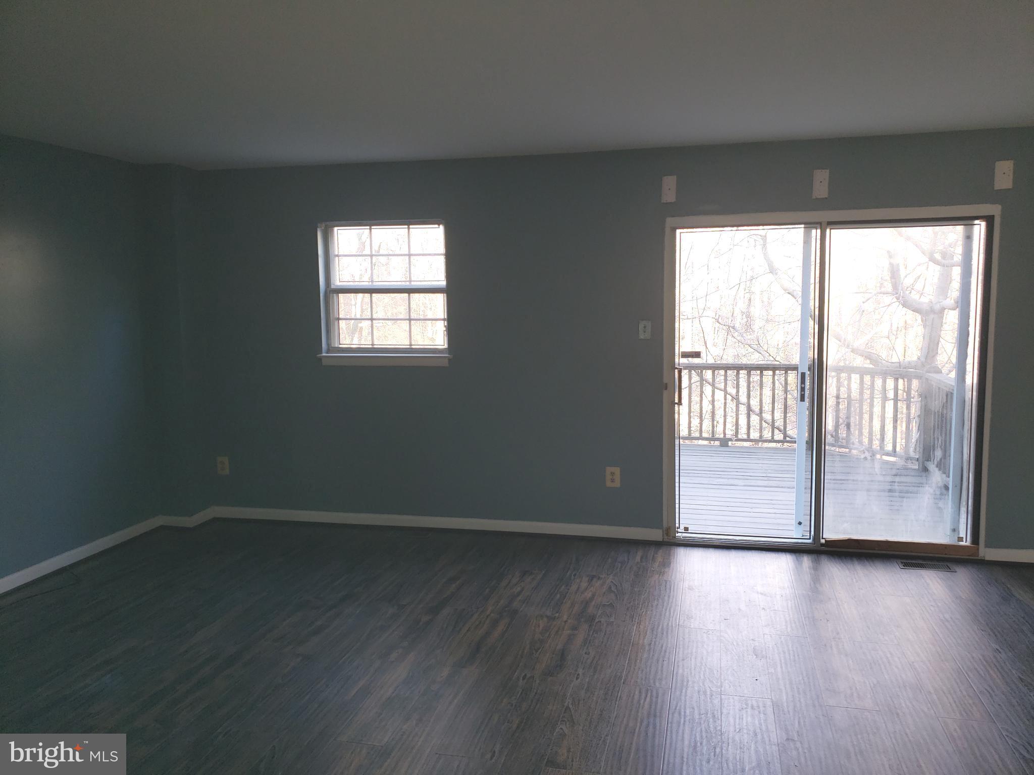 4 Mainview Court Randallstown, MD 21133 - Photo 6 of 25 a view of an empty room with wooden floor and a window