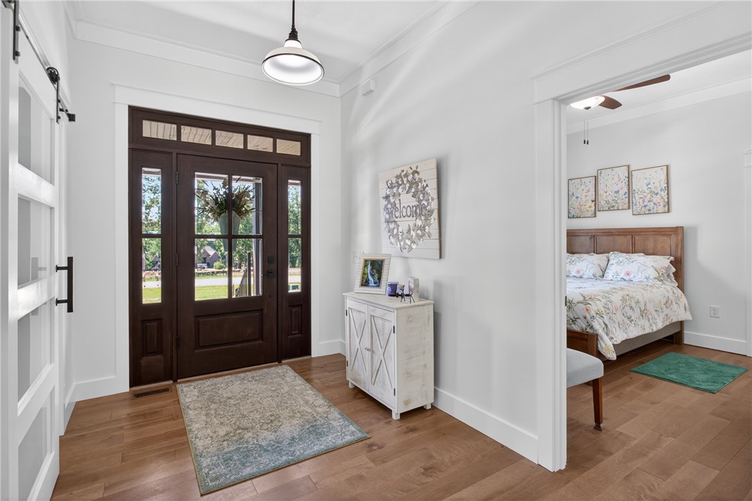 921 Falling Waters Lane Seneca, SC 29672 - Photo 4 of 46 Enter through a warm, glazed entry door with sidelights and transom window, welcoming you into this inviting space.