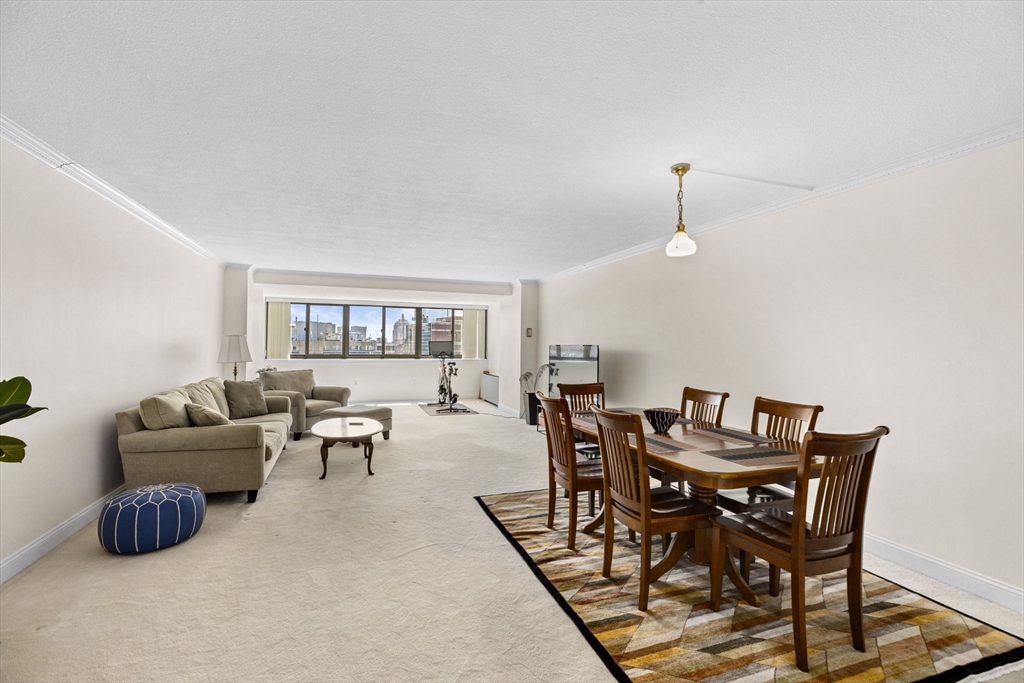 9 Hawthorne Place, Unit 14N Boston, MA 02114 - Photo 1 of 15 a dining room with furniture and wooden floor