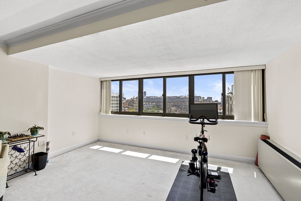 9 Hawthorne Place, Unit 14N Boston, MA 02114 - Photo 3 of 15 a view of a room with gym equipment and a large window