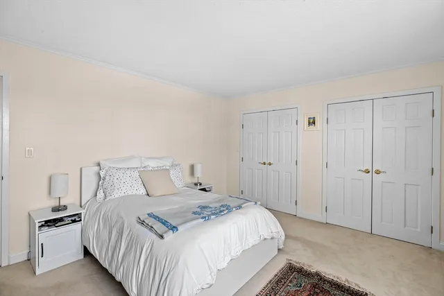 a bedroom with a bed and cabinets