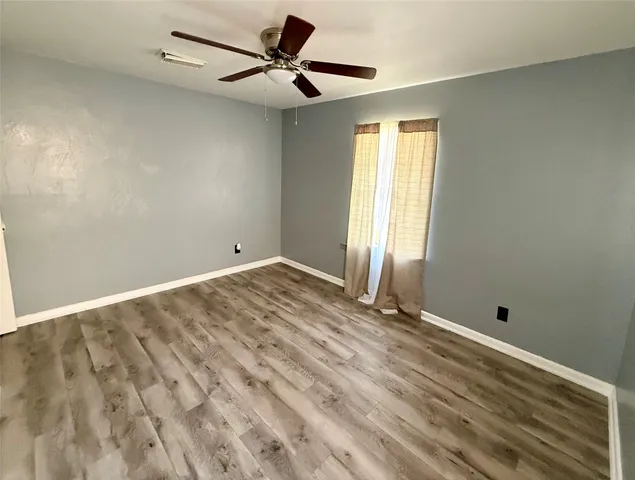 a view of room with window and ceiling fan