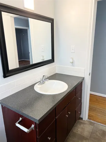 a bathroom with a sink and a mirror