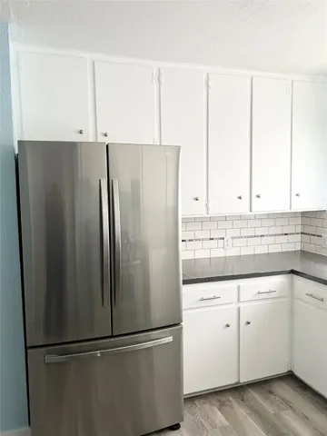a white refrigerator freezer sitting in a kitchen