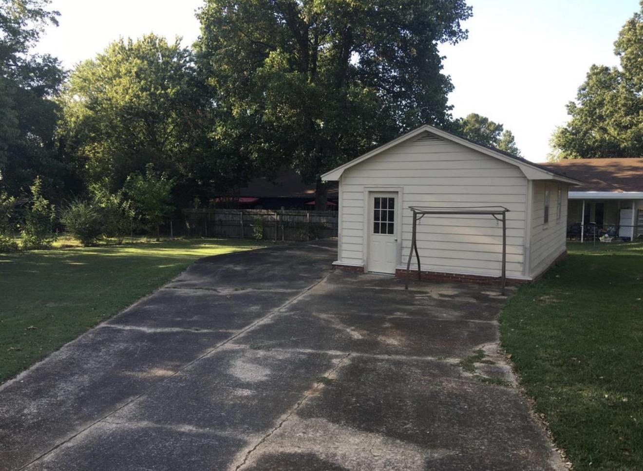 73 Hughes Drive Jackson, TN 38305 - Photo 12 of 24 a view of a house with a yard and a garage