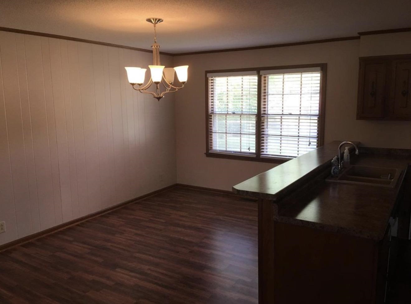 73 Hughes Drive Jackson, TN 38305 - Photo 18 of 24 a view of a kitchen with wooden floor and a window