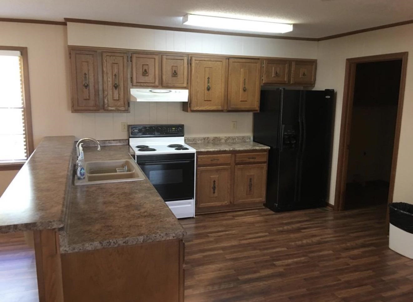 73 Hughes Drive Jackson, TN 38305 - Photo 20 of 24 a kitchen with a sink stove and refrigerator