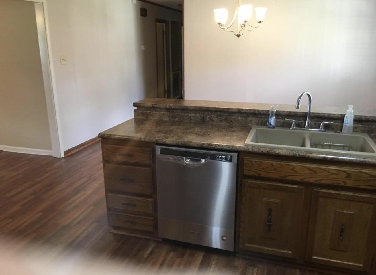 73 Hughes Drive Jackson, TN 38305 - Photo 21 of 24 a kitchen with granite countertop a sink and a stove