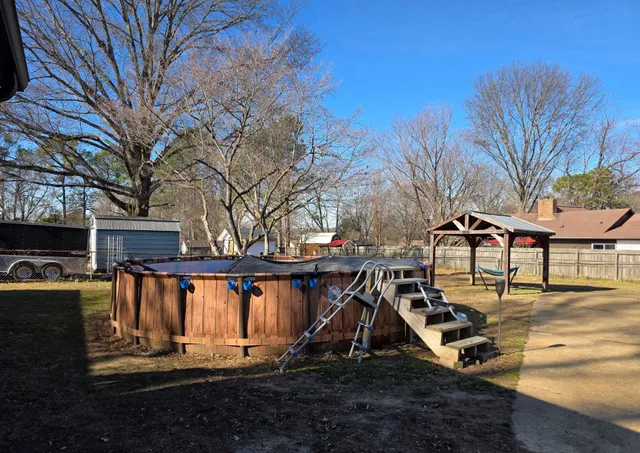 a view of a house with backyard water fountain and sitting area