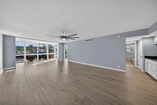 a living room with furniture a table and a large window
