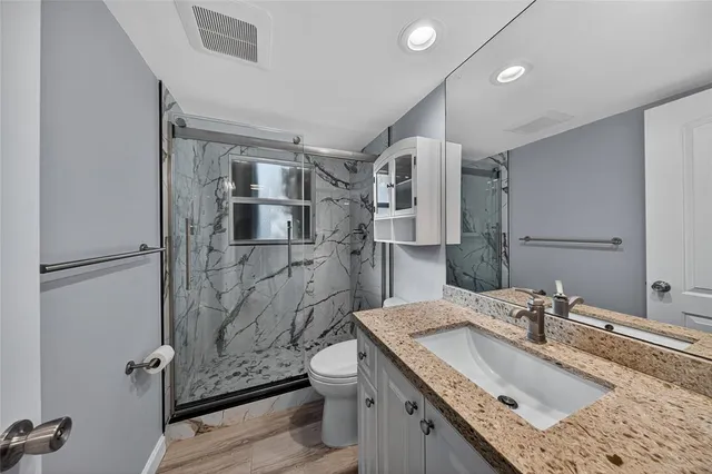 a kitchen that has a sink a stove and chairs